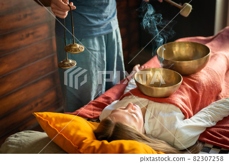 Tibetan singing bowls in sound therapy in spa center 82307258