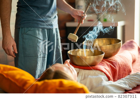 Tibetan singing bowls in sound therapy in spa center 82307311