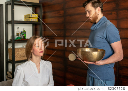 Tibetan singing bowls in sound therapy in spa center 82307328