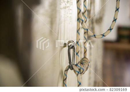 Yoga ropes hanging on empty studio wall. Iyengar yoga Yoga ropes hanging on empty studio wall. Iyengar yoga 82309169