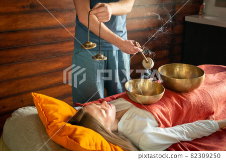 Tibetan singing bowls in sound therapy in spa center 82309250