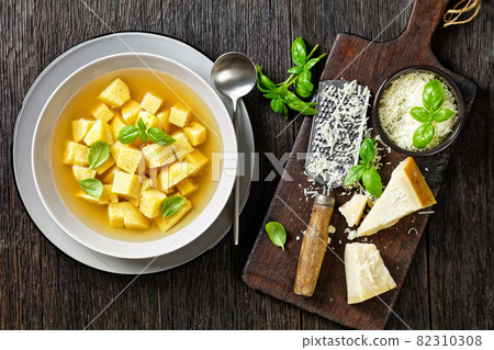 soup of chicken broth with parmesan egg dumplings 82310308