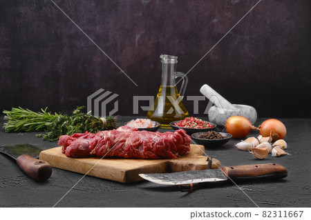 Raw lamb boneless neck meat on cutting board Raw lamb boneless neck meat on cutting board 82311667