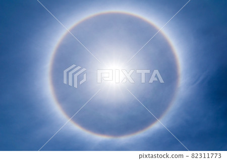 The sun shines brightly in the sky and natural phenomenon called circumscribed halo The sun shines brightly in the sky and natural phenomenon called circumscribed halo 82311773