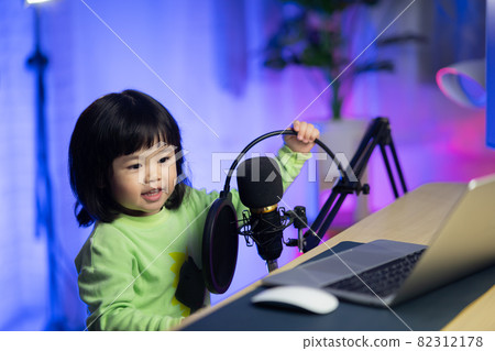 baby girl singing with headphone recording new song with microphone in the home recording studio baby girl singing with headphone recording new song with microphone in the home recording studio 82312178