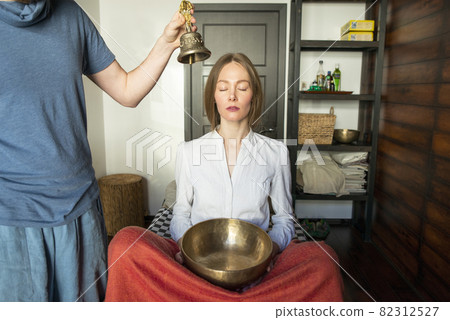 Tibetan singing bowls and bell in sound therapy in spa center 82312527