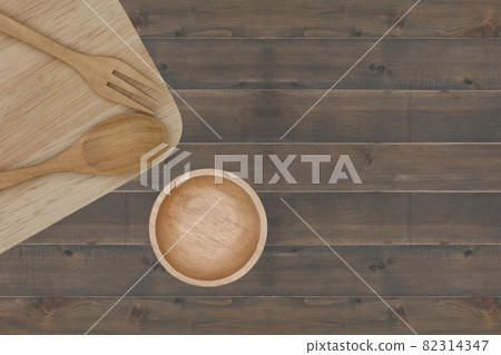 kitchenware : spoon, fork, cup, chopsticks and cutting board placed on wooden table kitchenware : spoon, fork, cup, chopsticks and cutting board placed on wooden table 82314347