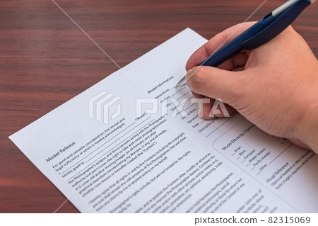 Signing a model release for permission to publish photos 82315069