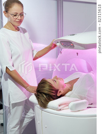 Modern spa treatment capsule in cosmetology clinic, cosmetologist operating equipment Modern spa treatment capsule in cosmetology clinic, cosmetologist operating equipment 82315618