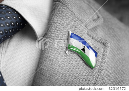 Metal badge with the flag of Lesotho on a suit lapel 82316572