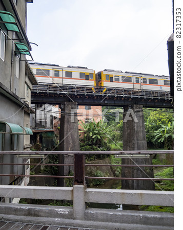 Train of Pingxi Railway Line traveling in Pinghsi old street, New Taipei City, Taiwan 82317353
