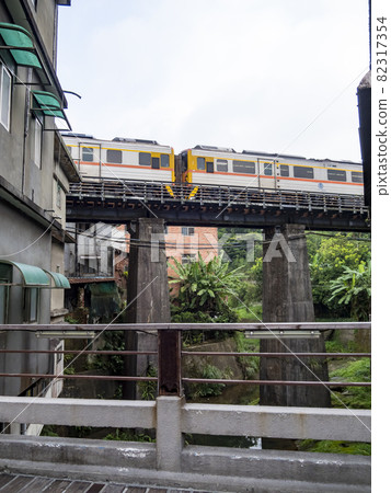 Train of Pingxi Railway Line traveling in Pinghsi old street, New Taipei City, Taiwan 82317354