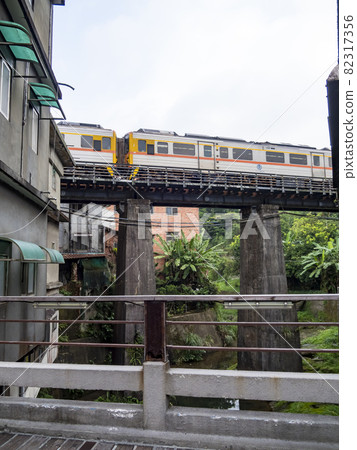 Train of Pingxi Railway Line traveling in Pinghsi old street, New Taipei City, Taiwan Train of Pingxi Railway Line traveling in Pinghsi old street, New Taipei City, Taiwan 82317356