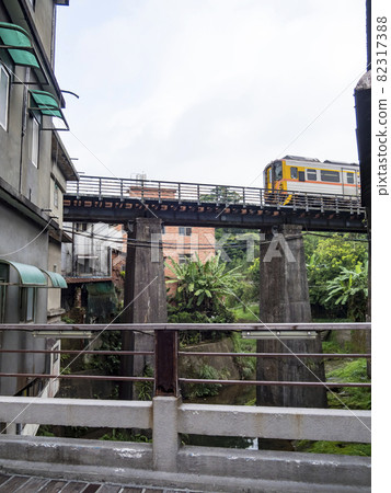 Train of Pingxi Railway Line traveling in Pinghsi old street, New Taipei City, Taiwan 82317388