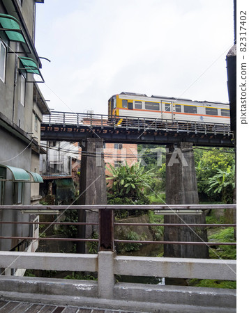 Train of Pingxi Railway Line traveling in Pinghsi old street, New Taipei City, Taiwan 82317402