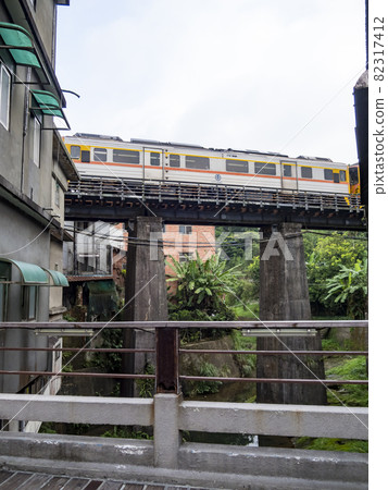 Train of Pingxi Railway Line traveling in Pinghsi old street, New Taipei City, Taiwan 82317412