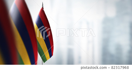 Small flags of Mauritius on a blurry background of the city Small flags of Mauritius on a blurry background of the city 82317968