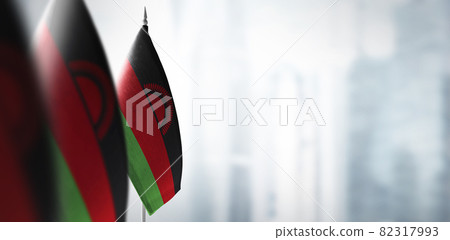 Small flags of Malawi on a blurry background of the city 82317993