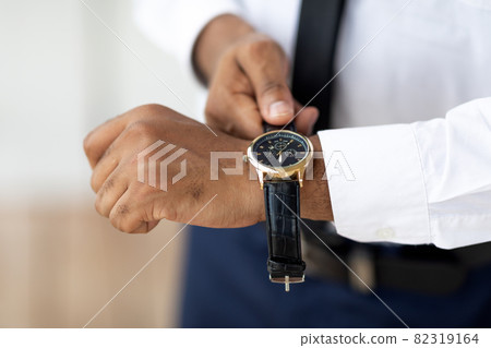 African American businessman wearing expensive wrist watch 82319164