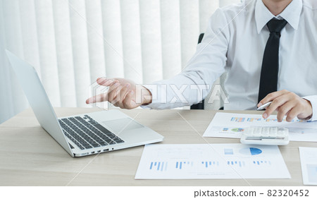 The businessman hand sits at their desks and calculates financial graphs showing the results of their investments planning the process of successful business growth The businessman hand sits at their desks and calculates financial graphs showing the results of their investments planning the process of successful business growth 82320452