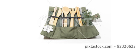 Christmas banner with set of eco friendly cutlery and hygiene products in case with snowflake and fir twig on white. 82320622