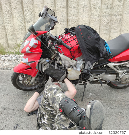 Man repair motorbike on road Man repair motorbike on road 82320767