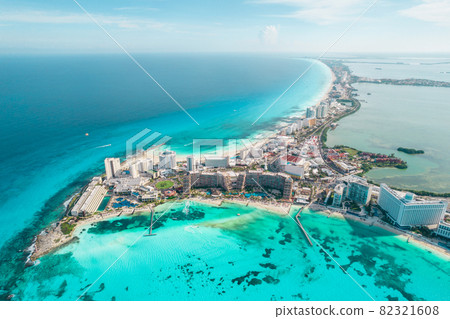 Aerial panoramic view of Cancun beach and city hotel zone in Mexico. Caribbean coast landscape of Mexican resort with beach Playa Caracol and Kukulcan road. Riviera Maya in Quintana roo region on 82321608