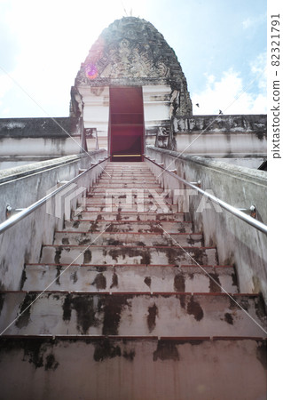 High angle view of ancient pagoda with steps in foreground and flare sunlight in background High angle view of ancient pagoda with steps in foreground and flare sunlight in background 82321791
