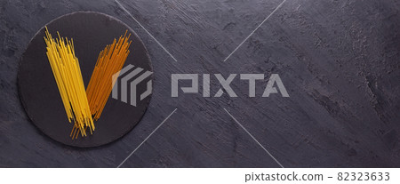 Pasta spaghetti food on table background. Raw pasta at slate stone 82323633