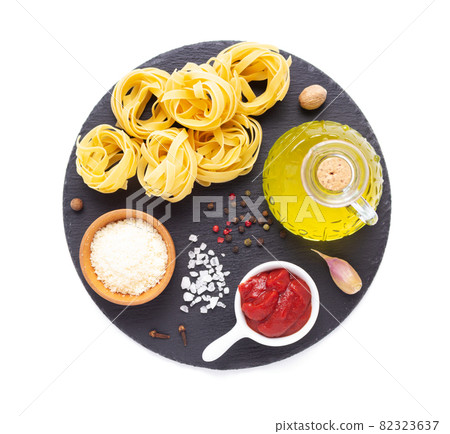 Pasta food  ingredients isolated at white background. Raw pasta fettuccine on slate stone 82323637