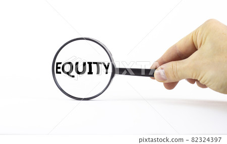 Equity and inclusion symbol. Magnifying glass with word equity on a beautiful white background. Businessman hand. Business, equity and inclusion concept, copy space. 82324397