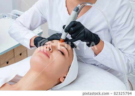 Face Skin Care. Closeup Of Woman Face Cleansing At Cosmetology clinic, vacuum cleaning Face Skin Care. Closeup Of Woman Face Cleansing At Cosmetology clinic, vacuum cleaning 82325794