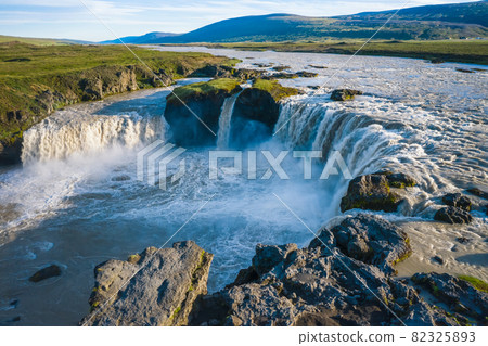 The aerial view of the beautiful waterfall of Godafoss after rainy days, Iceland in the summer season The aerial view of the beautiful waterfall of Godafoss after rainy days, Iceland in the summer season 82325893