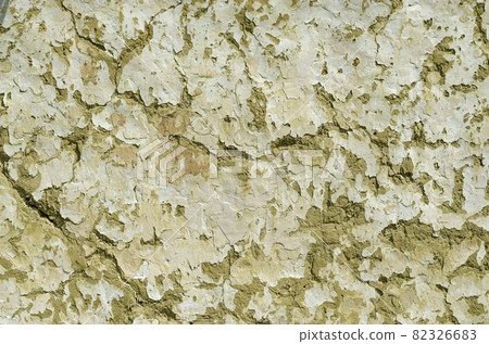 Clay wall. Wall background with shabby paint and crack, old hut wall. Cracks in the wall of a hut. Abstract background Clay wall. Wall background with shabby paint and crack, old hut wall. Cracks in the wall of a hut. Abstract background 82326683
