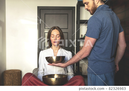 Tibetan singing bowls in sound therapy in spa center 82326983