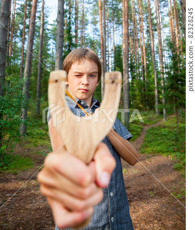 Kid with slingshot Kid with slingshot 82328245