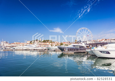 Morning in port of Cannes with luxury boats and old town Morning in port of Cannes with luxury boats and old town 82328531