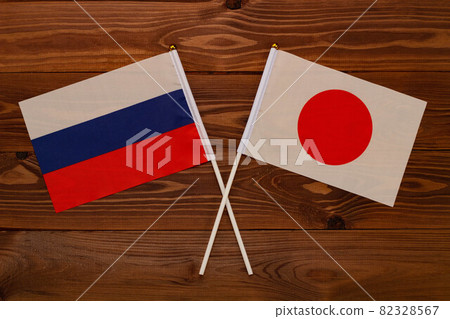 Flag of Russia and flag of Japan crossed with each other. The image illustrates the relationship between countries. Photography for video news on TV and articles on the Internet and media. Flag of Russia and flag of Japan crossed with each other. The image illustrates the relationship between countries. Photography for video news on TV and articles on the Internet and media. 82328567