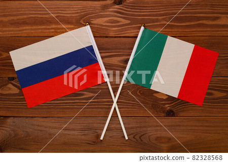 Flag of Russia and flag of Italy crossed with each other. The image illustrates the relationship between countries. Photography for video news on TV and articles on the Internet and media. Flag of Russia and flag of Italy crossed with each other. The image illustrates the relationship between countries. Photography for video news on TV and articles on the Internet and media. 82328568