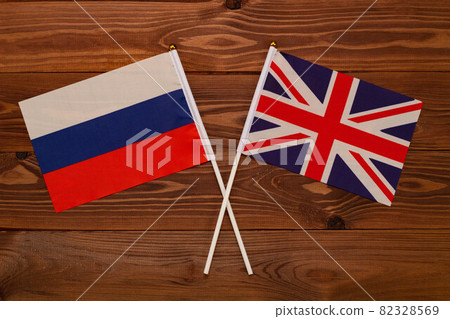 Flag of Russia and flag of Great Britain crossed with each other. The image illustrates the relationship between countries. Photography for video news on TV and articles on the Internet and media. Flag of Russia and flag of Great Britain crossed with each other. The image illustrates the relationship between countries. Photography for video news on TV and articles on the Internet and media. 82328569