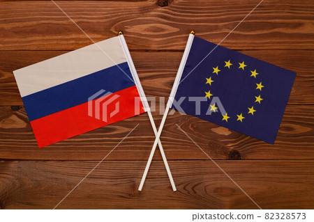 Flag of Russia and flag of European Union crossed with each other. The image illustrates the relationship between countries. Photography for video news on TV and articles on the Internet and media. Flag of Russia and flag of European Union crossed with each other. The image illustrates the relationship between countries. Photography for video news on TV and articles on the Internet and media. 82328573