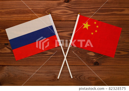 Flag of Russia and flag of China crossed with each other. The image illustrates the relationship between countries. Photography for video news on TV and articles on the Internet and media. Flag of Russia and flag of China crossed with each other. The image illustrates the relationship between countries. Photography for video news on TV and articles on the Internet and media. 82328575