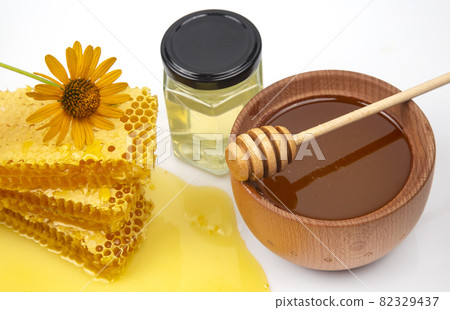 Fresh flower honey in a wooden bowl, spoon and honeycomb. vitamin food for health and life 82329437