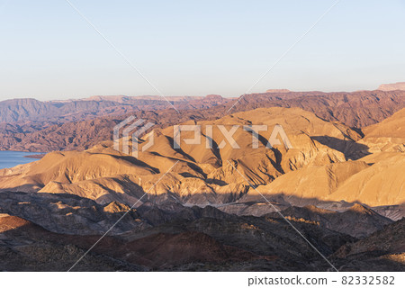 Arid desert mountains against the backdrop of the Red Sea. Shlomo mountain, Eilat Israel. Morning Daylight Arid desert mountains against the backdrop of the Red Sea. Shlomo mountain, Eilat Israel. Morning Daylight 82332582