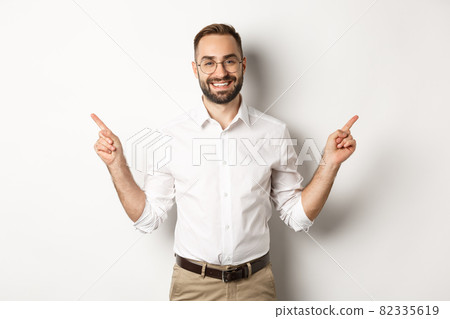 Confident bearded man smiling, pointing left and right at copy spaces, standing over white background Confident bearded man smiling, pointing left and right at copy spaces, standing over white background 82335619