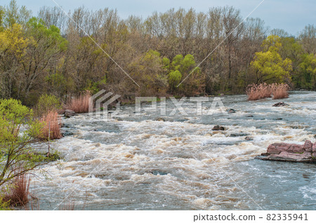 Fast flowing cold water mountain stream, flowing stormy Fast flowing cold water mountain stream, flowing stormy 82335941