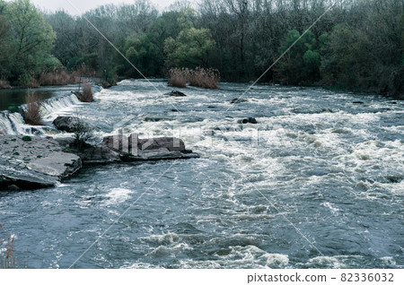 Rocky fast river. Running water, flowing with rapids Rocky fast river. Running water, flowing with rapids 82336032