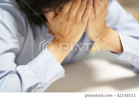 雙手摀臉的中年婦女 雙手摀臉的中年婦女 82338521