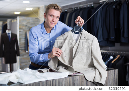 seller holding jacket in the dress shop seller holding jacket in the dress shop 82339291