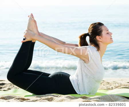 Female 20-30 years old is practicing stretching in white T-shirt Female 20-30 years old is practicing stretching in white T-shirt 82339801